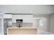 Modern kitchen featuring stainless appliances, a sleek island, and abundant cabinet space at 5625 Gateway Dr, Tampa, FL 33615
