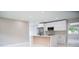 Modern kitchen featuring stainless appliances, a sleek island, and abundant cabinet space at 5625 Gateway Dr, Tampa, FL 33615