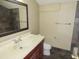 Bathroom featuring single vanity, framed mirror, ceramic toilet and tiled accent wall at 5736 116Th N Ave, Pinellas Park, FL 33782