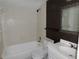 Bathroom featuring bathtub, toilet, sink and vanity, and brown tile accent at 5736 116Th N Ave, Pinellas Park, FL 33782