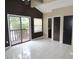 Bright bedroom with a sliding glass door to deck, a neutral paint scheme and tile flooring at 5736 116Th N Ave, Pinellas Park, FL 33782