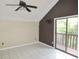 Bedroom with sliding glass doors to deck, ceiling fan, and stylish accent wall at 5736 116Th N Ave, Pinellas Park, FL 33782