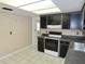 Kitchen features tile flooring, black cabinetry, and gray counter tops at 5736 116Th N Ave, Pinellas Park, FL 33782
