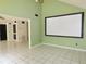 Open room with tile flooring and green walls and a blank screen with access to other rooms at 5736 116Th N Ave, Pinellas Park, FL 33782