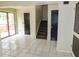 Spacious living area with tile flooring, sliding glass door, and stair access at 5736 116Th N Ave, Pinellas Park, FL 33782