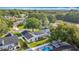 An aerial view showcasing this homes solar panels, pool, and beautiful landscaping in a residential neighborhood at 5808 Silver Moon Ave, Tampa, FL 33625