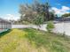 Backyard features a well maintained lawn, shade trees, and newer vinyl privacy fence at 5808 Silver Moon Ave, Tampa, FL 33625