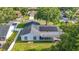 Backyard of home featuring solar panels, screened-in porch and a spacious green lawn at 5808 Silver Moon Ave, Tampa, FL 33625