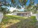 Expansive backyard with lush green grass and a white fence for added privacy at 5808 Silver Moon Ave, Tampa, FL 33625