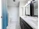 Bathroom featuring a double vanity with white marble floors and a shower with a blue curtain at 5808 Silver Moon Ave, Tampa, FL 33625