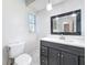 Bathroom featuring a toilet and vanity with marble-look tile and an open window at 5808 Silver Moon Ave, Tampa, FL 33625