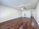 Spacious bedroom featuring hardwood floors, a ceiling fan, and views of the bathroom and closet at 5808 Silver Moon Ave, Tampa, FL 33625