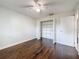 Bedroom showcasing laminate flooring and a closet with open doors, featuring a ceiling fan at 5808 Silver Moon Ave, Tampa, FL 33625