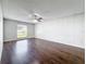 Spacious bedroom featuring a ceiling fan and wood-look flooring with a window allowing natural light at 5808 Silver Moon Ave, Tampa, FL 33625
