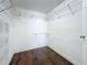 Walk in closet with adjustable shelving and wood-look flooring in a neutral color at 5808 Silver Moon Ave, Tampa, FL 33625
