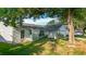Charming single-story home with a well-manicured front yard and mature shade trees at 5808 Silver Moon Ave, Tampa, FL 33625