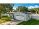 Charming one-story home with a well-manicured lawn and a two-car garage, showcasing curb appeal at 5808 Silver Moon Ave, Tampa, FL 33625