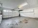 Spacious garage with white walls and ceiling, featuring ample storage cabinets and a door opener at 5808 Silver Moon Ave, Tampa, FL 33625
