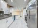 Bright kitchen with stainless steel appliances, granite countertops, stylish backsplash and white cabinets at 5808 Silver Moon Ave, Tampa, FL 33625