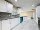 Bright kitchen features stainless steel appliances, granite countertops, stylish backsplash and white cabinets at 5808 Silver Moon Ave, Tampa, FL 33625