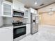 Well-lit kitchen features stainless steel appliances, granite countertops, and stylish backsplash at 5808 Silver Moon Ave, Tampa, FL 33625