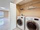 Bright laundry room equipped with modern washer and dryer, ample shelving at 5808 Silver Moon Ave, Tampa, FL 33625