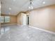 Spacious living room features modern chandelier, neutral paint, and tile floors at 5808 Silver Moon Ave, Tampa, FL 33625