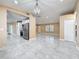 Open living space featuring tile floors, pendant lighting and an adjoining kitchen with stainless appliances at 5808 Silver Moon Ave, Tampa, FL 33625