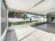 Enclosed patio includes a screened area, tiled floors, and backyard views of the fence line at 5808 Silver Moon Ave, Tampa, FL 33625