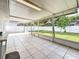 Enclosed patio features tiled floors, outdoor string lights, and a view of the backyard at 5808 Silver Moon Ave, Tampa, FL 33625