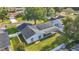 Aerial view of a light blue home featuring solar panels, a screened-in porch, and a fenced backyard at 5808 Silver Moon Ave, Tampa, FL 33625