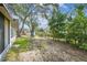 Spacious backyard with lush greenery and a mix of sunny and shaded areas at 5825 Oakhurst Dr, Seminole, FL 33772