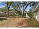Backyard with mature trees, offering plenty of shade at 5825 Oakhurst Dr, Seminole, FL 33772