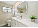Bright bathroom featuring a modern vanity with white countertop, an elegant mirror, and decorative plants at 5825 Oakhurst Dr, Seminole, FL 33772
