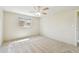 This bedroom features a ceiling fan and a window, neutral walls, and carpeted floors at 5825 Oakhurst Dr, Seminole, FL 33772