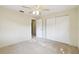 Bedroom featuring neutral walls, plush carpeting, a ceiling fan and a closet at 5825 Oakhurst Dr, Seminole, FL 33772