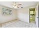 Bedroom with neutral walls, plush carpeting, ceiling fan and a view into an adjacent room at 5825 Oakhurst Dr, Seminole, FL 33772