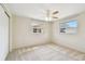 Bright bedroom with neutral walls, carpeted floors, ceiling fan, and windows at 5825 Oakhurst Dr, Seminole, FL 33772