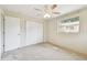 Bedroom with neutral walls, plush carpeting, ceiling fan, closet, and window at 5825 Oakhurst Dr, Seminole, FL 33772