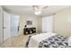 This bedroom features a ceiling fan and window, complete with stylish modern accents and carpeted floors at 5825 Oakhurst Dr, Seminole, FL 33772