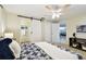 This bedroom features a barn door to the bathroom and a ceiling fan, complete with stylish modern accents at 5825 Oakhurst Dr, Seminole, FL 33772