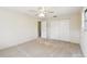 This bedroom features a ceiling fan, closet, a window with AC, neutral walls, and carpeted floors at 5825 Oakhurst Dr, Seminole, FL 33772