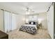 Relaxing bedroom with ceiling fan, carpet, and sliding barn door for en suite access at 5825 Oakhurst Dr, Seminole, FL 33772