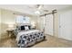 Relaxing bedroom with ceiling fan, carpet, and sliding barn door for en suite access at 5825 Oakhurst Dr, Seminole, FL 33772