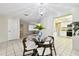 Charming dining room features a glass table, chandelier, and views into the kitchen and living room at 5825 Oakhurst Dr, Seminole, FL 33772