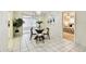 Cozy dining area with a glass table, four chairs, chandelier, and access to the lanai at 5825 Oakhurst Dr, Seminole, FL 33772