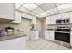 Updated kitchen featuring stainless steel appliances, granite countertops, and white cabinets at 5825 Oakhurst Dr, Seminole, FL 33772