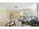 Bright living room featuring neutral decor, modern furniture, and a large window, creating a welcoming space at 5825 Oakhurst Dr, Seminole, FL 33772