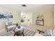 Bright living room with neutral walls, modern art, and a view into the dining area at 5825 Oakhurst Dr, Seminole, FL 33772