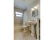 Bright bathroom featuring a pedestal sink, tub with shower, and decorative mirror at 6409 41St N Ave, St Petersburg, FL 33709